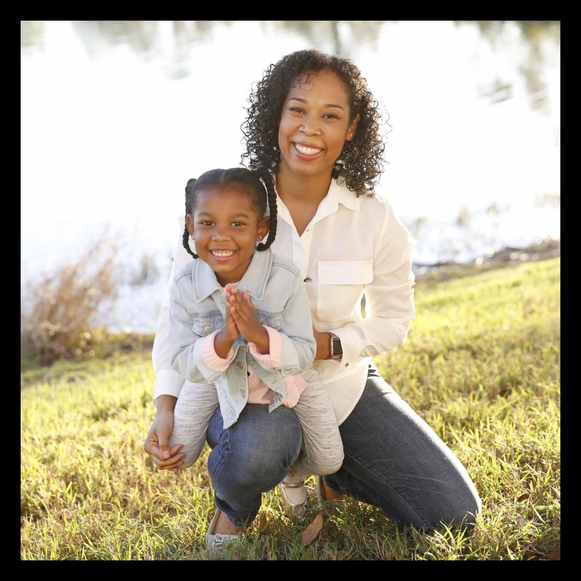 Woman and child sitting on grass in a park