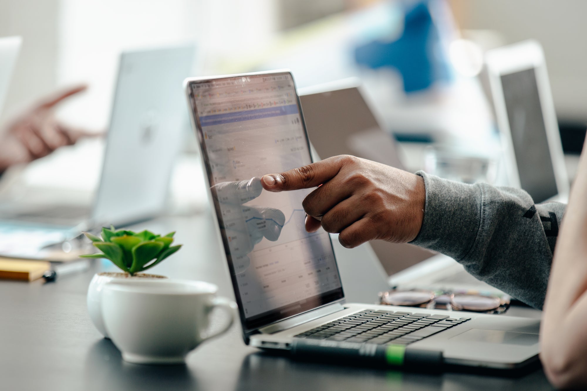 man pointing at laptop screen